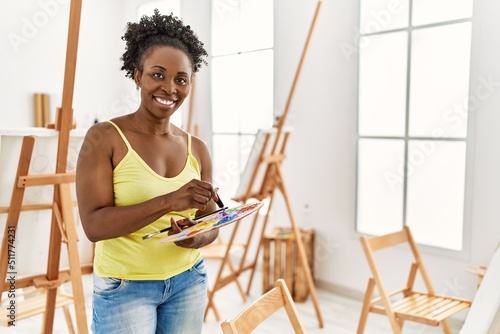 Young african american artist woman smiling happy drawing at art studio.