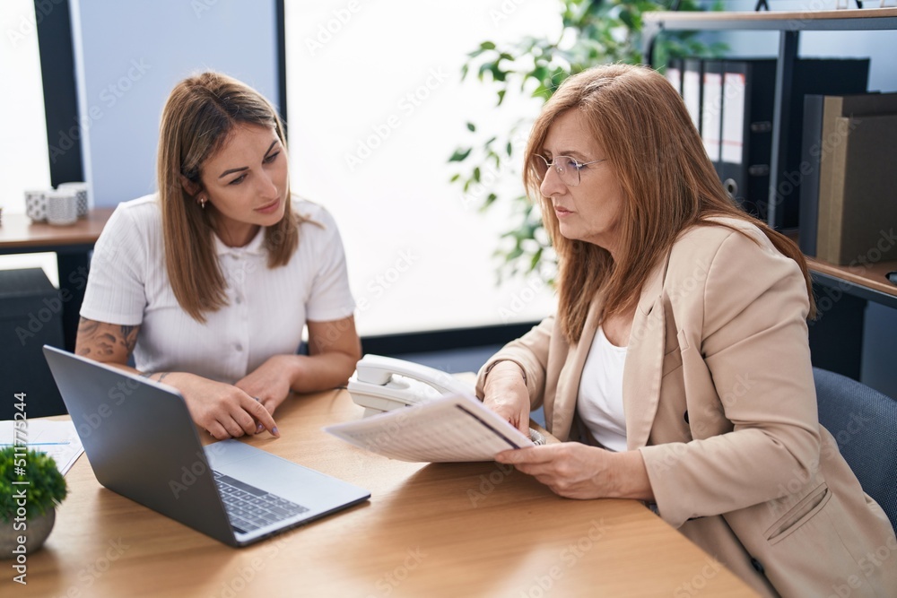 Mother and daughter business workers working at office