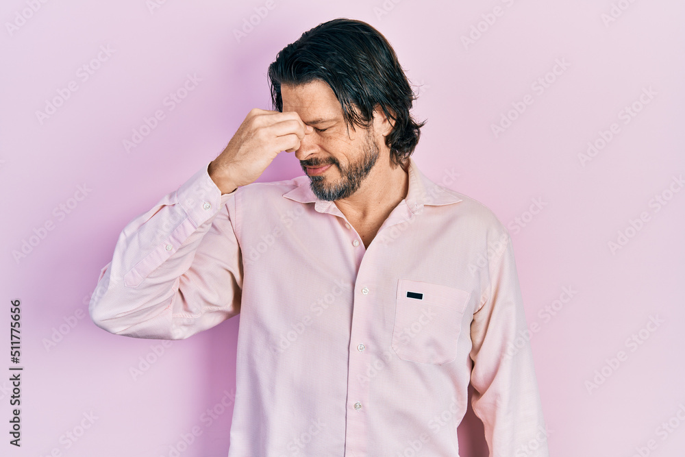Middle age caucasian man wearing casual clothes tired rubbing nose and eyes feeling fatigue and headache. stress and frustration concept. Middle age caucasian man wearing casual clothes tired rubbing nose and eyes feeling fatigue and headache. stress and frustration concept.
