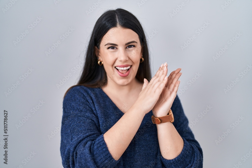 Young brunette woman standing over isolated background clapping and applauding happy and joyful, smiling proud hands together Young brunette woman standing over isolated background clapping and applauding happy and joyful, smiling proud hands together