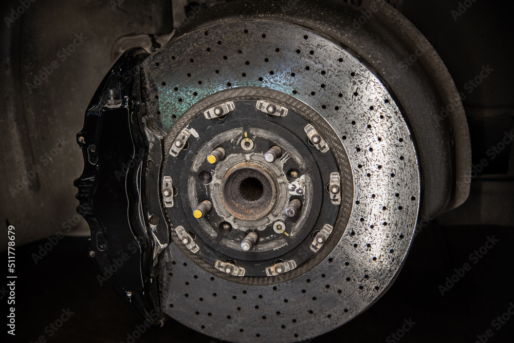 Massive brake caliper on carbon brake disk on a performance car
