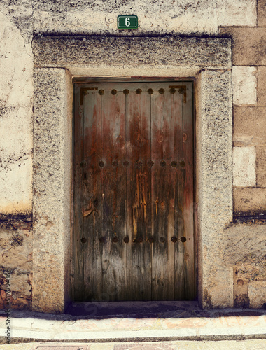 Old, picturesque main front door in mediterranean region house.