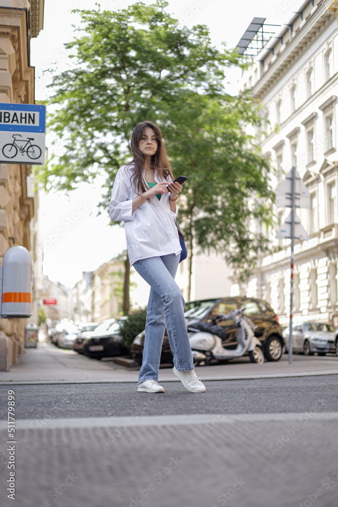 Freelance girl on the street with a phone leads her social life.