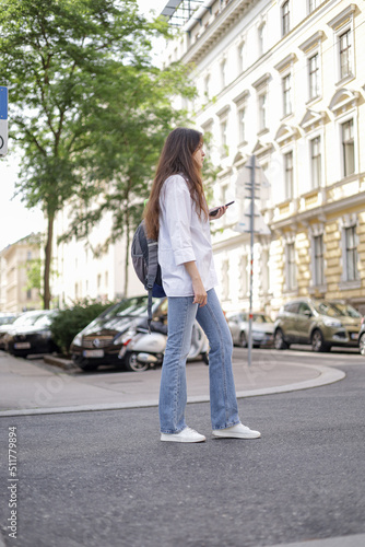 A girl in casual clothes walks in the city center. Beautiful life.