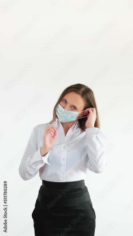Pandemic prevention. Office hygiene. Coronavirus quarantine safety measures. Vertical portrait of business woman wearing face mask shrugging isolated on white copy space.