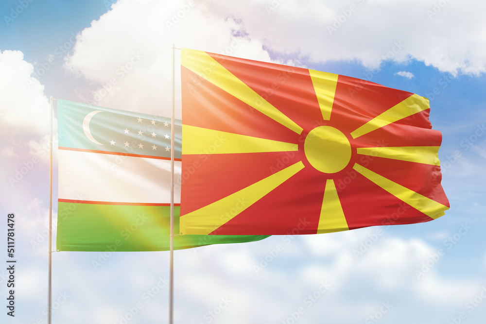 Sunny blue sky and flags of north macedonia and uzbekistan