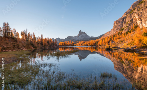 Amazing autumn scenery in the Dolomites mountains by the Lake Federa in the fall. National Unesco park in Italy. 