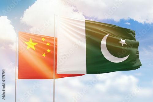 Sunny blue sky and flags of pakistan and china photo