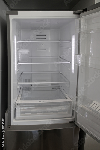 Refrigerator wit open door, very new and empty