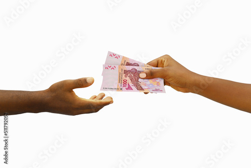 Hand giving 3D rendered CFA Franc notes to another hand. Hand receiving money photo