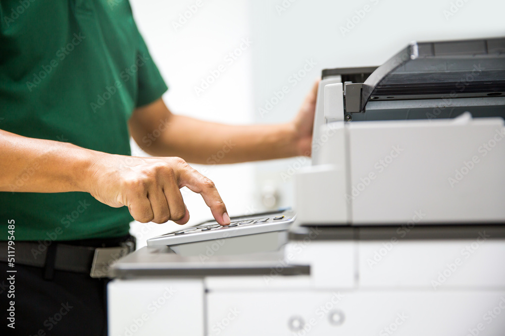 Photocopier printer, Close up hand office man press copy button on panel to using the copier or photocopy machine for scanning document or printing a sheet paper and xerox photocopy. - obrazy, fototapety, plakaty 