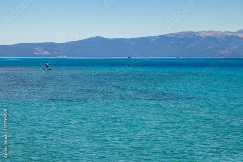 Standup paddleboarder enjoys the blue water of Lake Tahoe  © R