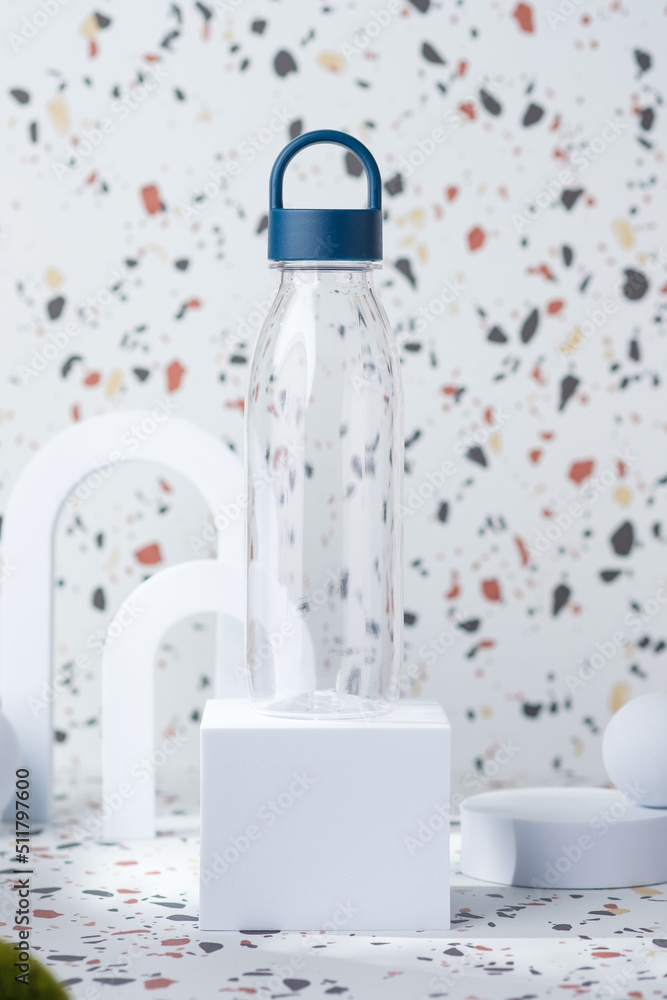 water bottle mockup on white geometric pedestal on terrazzo background with summer sunlight water bottle mockup on white geometric pedestal on terrazzo background with summer sunlight