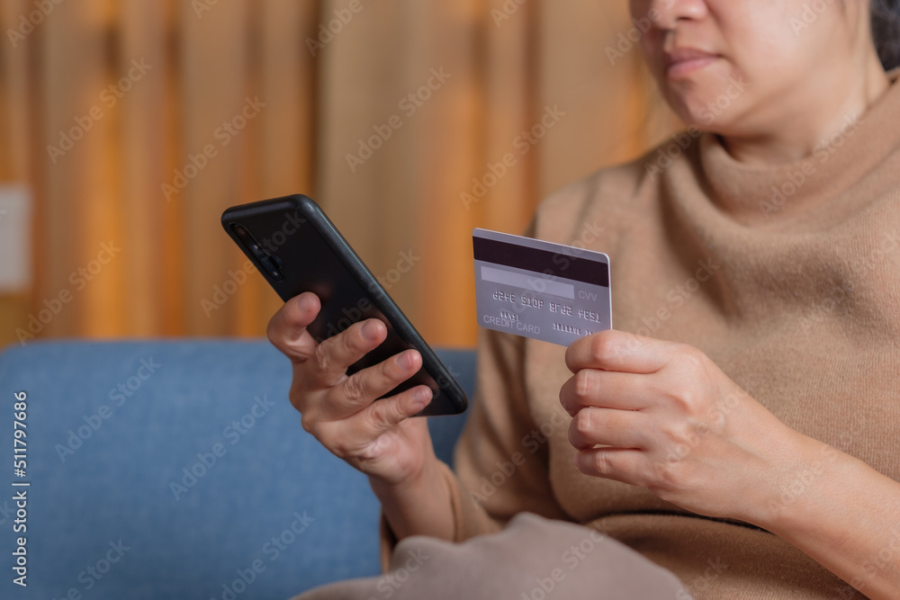 close up hand use credit card pay contactless online in mobile app shopping