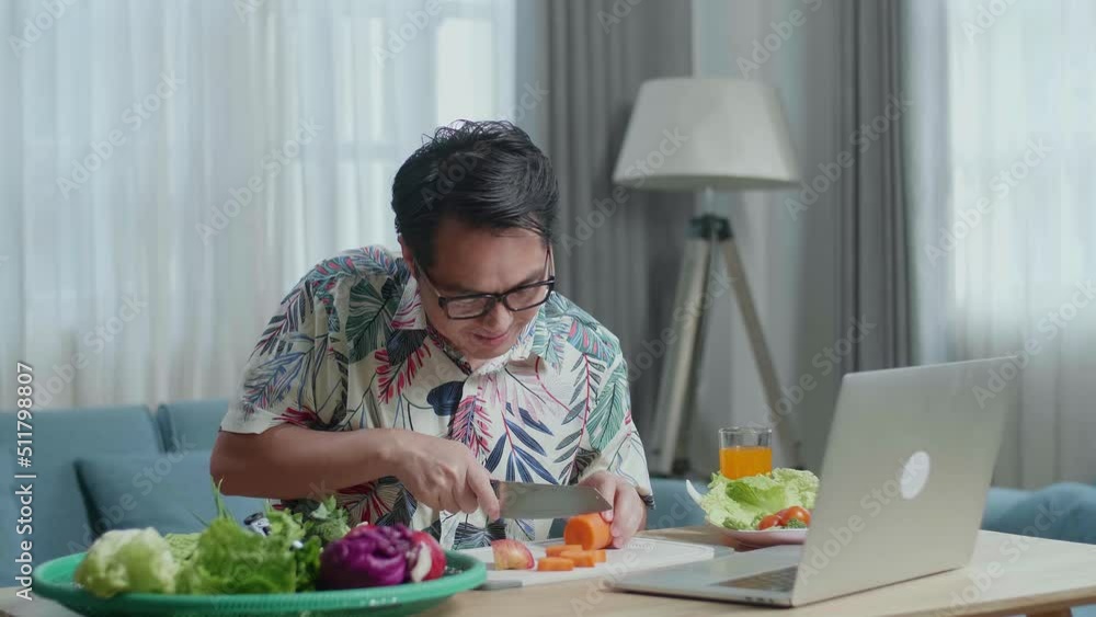 Smiling Asian Man Learn To Cooking Healthy Food Online With A Laptop At Home
Smiling Asian Man Learn To Cooking Healthy Food Online With A Laptop At Home