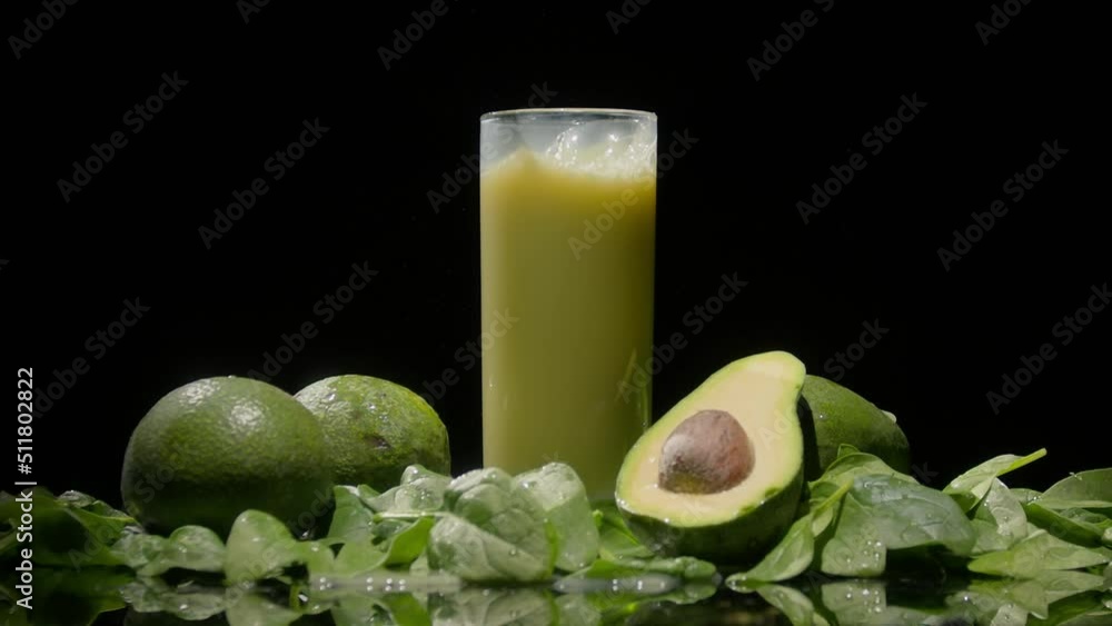 Splash of green detox smoothie, liquid pouring out of a glass Splash of green detox smoothie, liquid pouring out of a glass