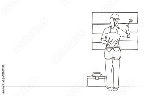 Single one line drawing woman professional worker in uniform hammering. Nail in wood. Construction work at home. Building, construction, repair work service. Continuous line draw design graphic vector