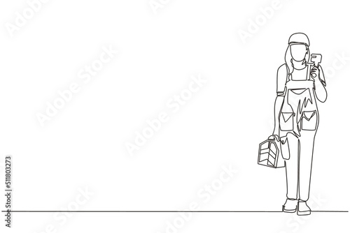 Single one line drawing woman plumber holding wrench and tools box in hands stands isolated. Professional servicewoman character in uniform ready for work. Continuous line draw design graphic vector