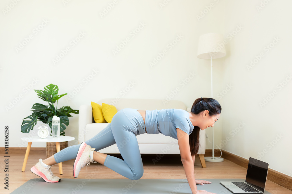 Healthy lifestyle young woman fitness gym for body slim. Young people girl exercise at living room on line. Fitness instructor exercising the fitness. Diet and Healthy sport Concept Healthy lifestyle young woman fitness gym for body slim. Young people girl exercise at living room on line. Fitness instructor exercising the fitness. Diet and Healthy sport Concept