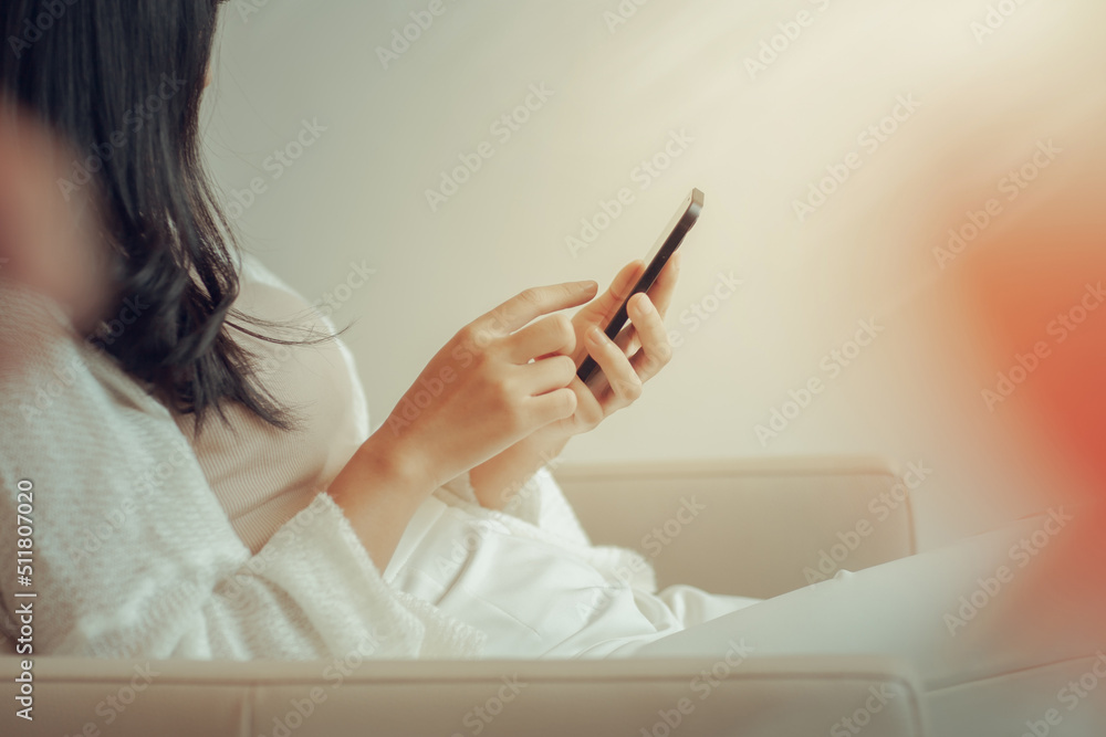 woman holding credit card with mobile phone at home using mobile phone and laptop shopping online online shopping concept woman holding credit card with mobile phone at home using mobile phone and laptop shopping online online shopping concept