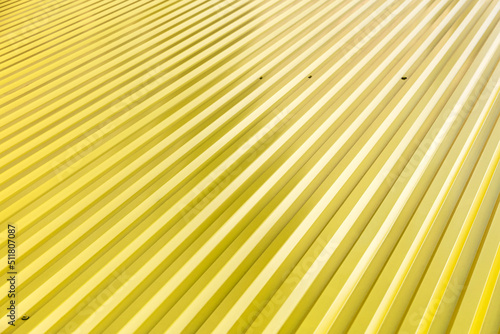 yellow corrugated metal roof with rivets. industrial background. closeup view.