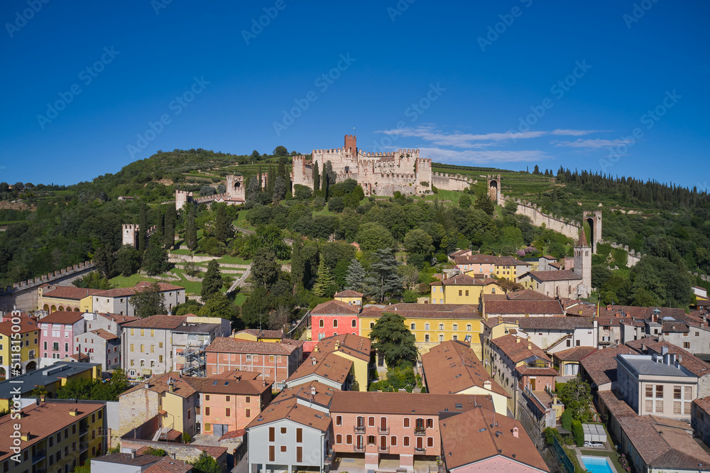 Ancient castle on a hill in Italy. Soave castle aerial view Verona province, Italy. View of Soave castle surrounded by vineyard plantations.