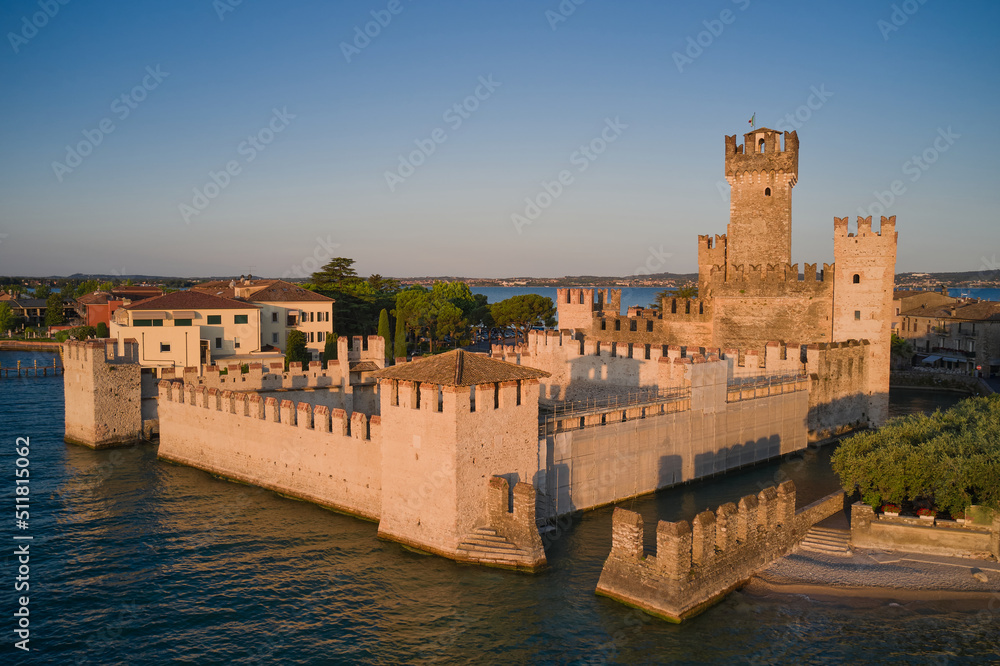 Aerial view of Scaligero Castle at sunrise. Sirmione aerial view on Lake Garda, Italy. Water castle on Lake Garda.