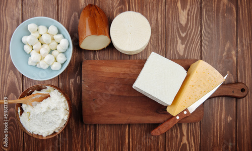 top view of different kind of cheese on rustic wooden background