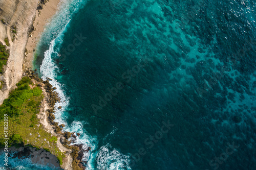 Obraz na plátně Aerial drone top view shot of rocky beach with cliff