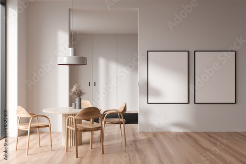 Light living room interior with seats and eating table, mockup frames