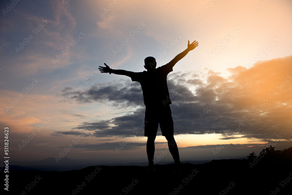 silhouette of a person with arms outstretched silhouette of a person with arms outstretched