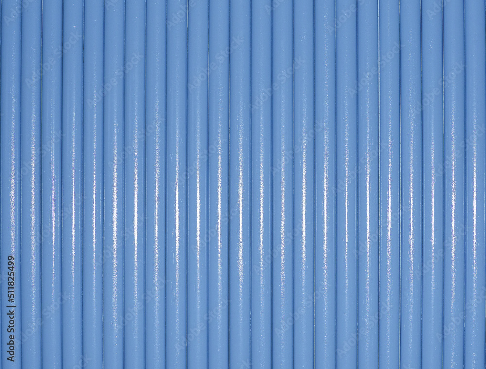 Abstract background image. Small round pillars, placed next to each other in blue rows. White reflections from neon lights. Abstract background image. Small round pillars, placed next to each other in blue rows. White reflections from neon lights.