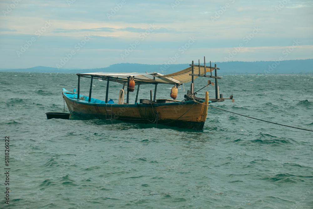 Traditional khmer wooden fishing boat moored at sea during the rainy season in Koh Sdach Island in Cambodia