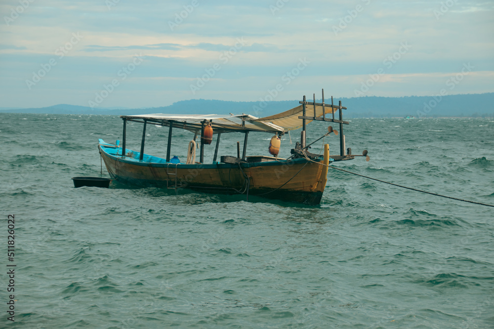 Traditional khmer wooden fishing boat moored at sea during the rainy season in Koh Sdach Island in Cambodia Traditional khmer wooden fishing boat moored at sea during the rainy season in Koh Sdach Island in Cambodia
