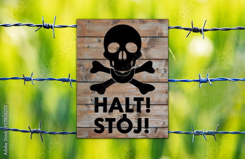 concentration camp,kz,camp,concentration,dead,skull,halt,stoj,wood,plate,sign,signboard, jew, black, grey,gray, green, war, barbed wire, barbwire photo