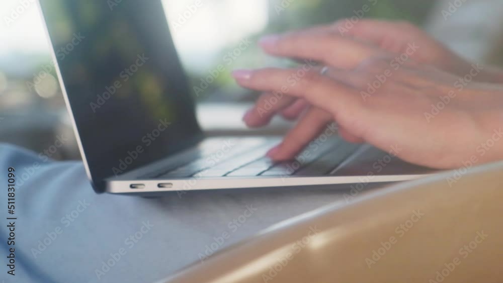 Female fingers pressing a keys on contemporary laptop. Working the computer outdoor. Notebook. Hand typing in keyboard. Closeup business woman's hands handheld outside. Female fingers pressing a keys on contemporary laptop. Working the computer outdoor. Notebook. Hand typing in keyboard. Closeup business woman's hands handheld outside.