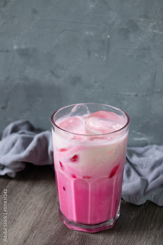 cold pink milk cold drink in clear glass on gray background. Thai milk cold pink milk cold drink in clear glass on gray background. Thai milk