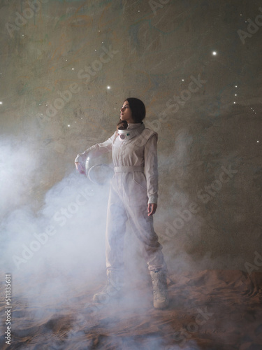 An astronaut on a desert planet alone, an explorer on a distant planet, other worlds and civilizations. A young woman in a retrofuturism-style white spacesuit stands on the sand and looks around
