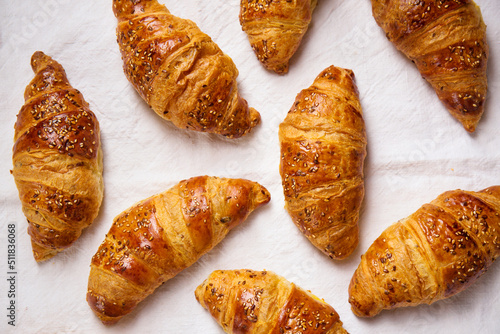 croissants on a textured white fabric, top view
