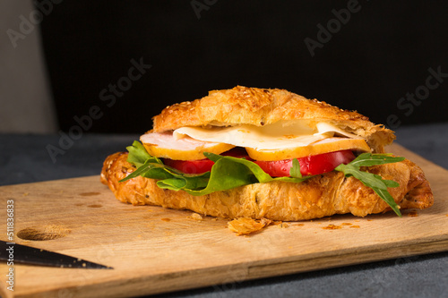 Cooked croissant with ham, cheese and vegetables