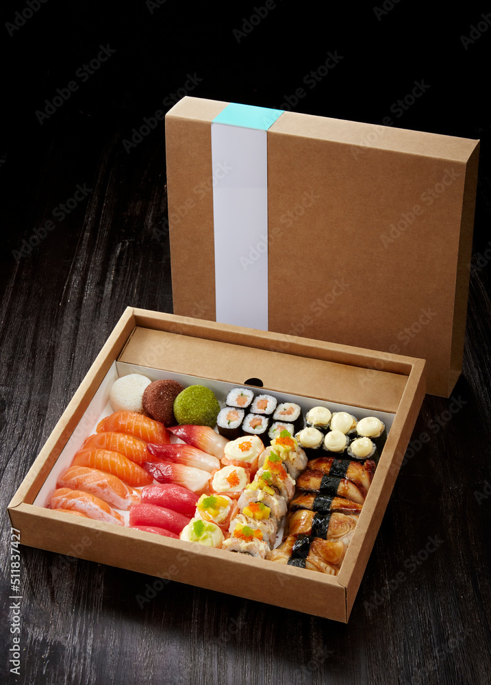 A delicious combination of Japanese sushi dishes ,in a paper takeaway package A delicious combination of Japanese sushi dishes ,in a paper takeaway package
