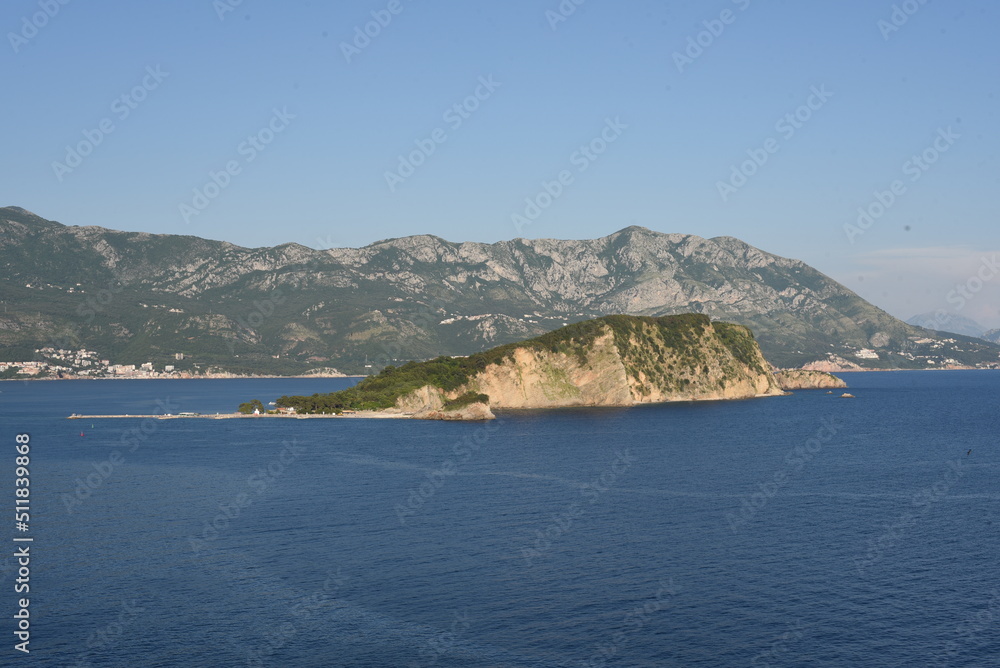 View from the sea. Large sea surface with numerous rocky islands. Mediterranean Blue Sea in Montenegro. Mountain Islands of Montenegro.