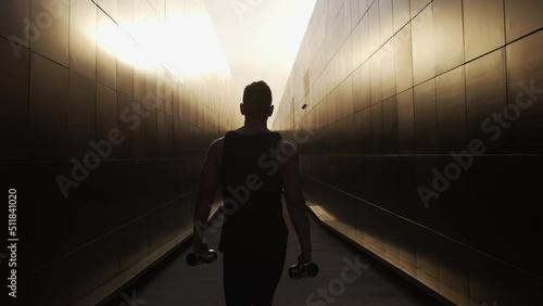 Young Muscular Man Doing Sports Outside at Sunset. Training of a Young Strong Athlete. Fitness and Healthy Lifestyle Concept.