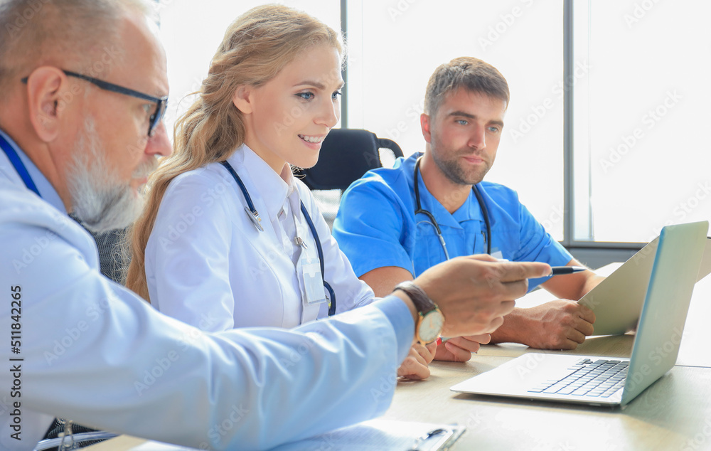 Team of modern doctors discussing the problems. Team of modern doctors discussing the problems.