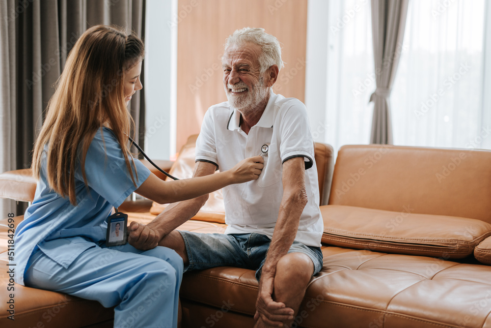 Young nurse caring elderly man at home. asian nurse helping senior man at home. Senior health care.