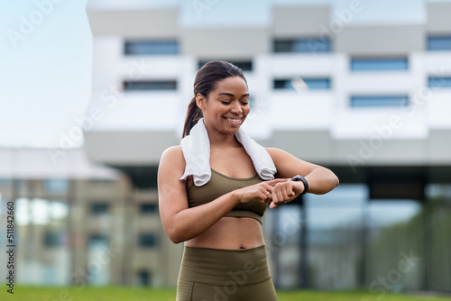 Portrait of happy fit young black woman checking smartwatch or fitness tracker outdoors Free Download Portrait of happy fit young black woman checking smartwatch or fitness tracker outdoors - GFXLoad