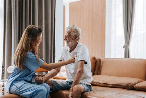 Young nurse caring elderly man at home. asian nurse helping senior man at home. Senior health care.