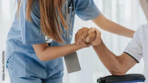 Obraz na plátně Nurse hand to helping and support senior man