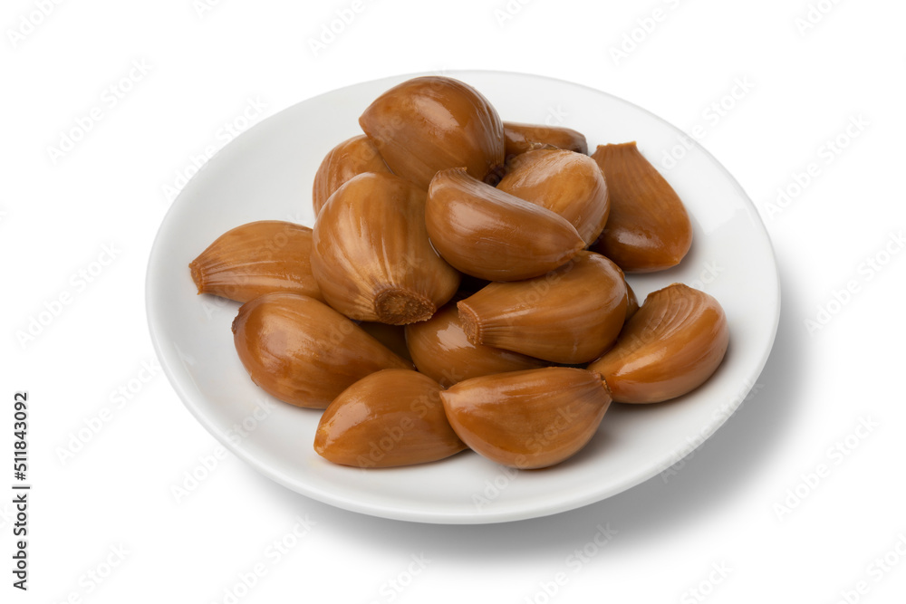 Plate with tasty pickled garlic cloves isolated on white background close up Plate with tasty pickled garlic cloves isolated on white background close up
