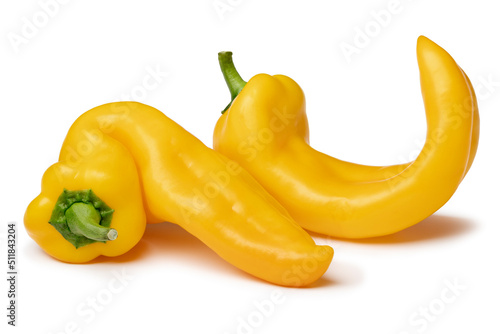 Pair of yellow deformed homegrown yellow pointed bell peppers isolated on white background photo